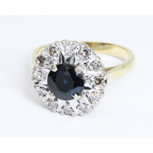 8 - A diamond and sapphire cluster ring, the central round cut sapphire measuring approximately 6.88 in ... 