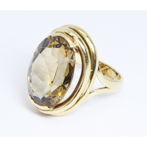 9 - A citrine ring, the oval cut stone measuring approximately 18.66mm x 13.12mm, depth 7.84mm and weigh... 