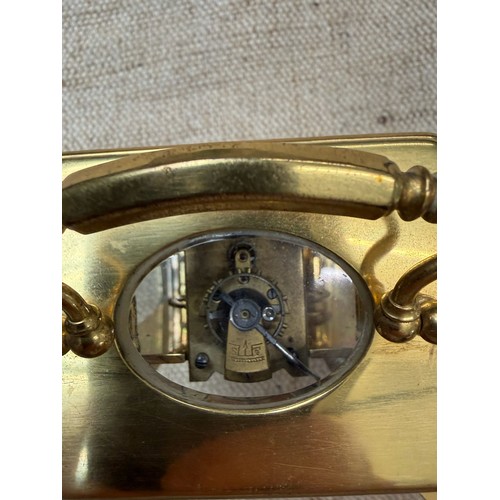 2 - A carriage clock by J Vincent, Weymouth, bearing a Harrods sticker to base, in wooden case