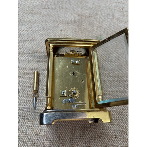 2 - A carriage clock by J Vincent, Weymouth, bearing a Harrods sticker to base, in wooden case