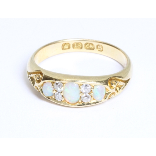 7 - A Victorian opal and diamond ring, the old European cut diamonds weighing approximately 0.10ct, the ... 
