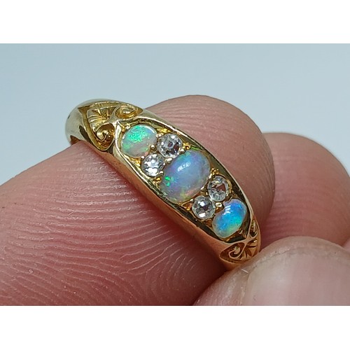 7 - A Victorian opal and diamond ring, the old European cut diamonds weighing approximately 0.10ct, the ... 