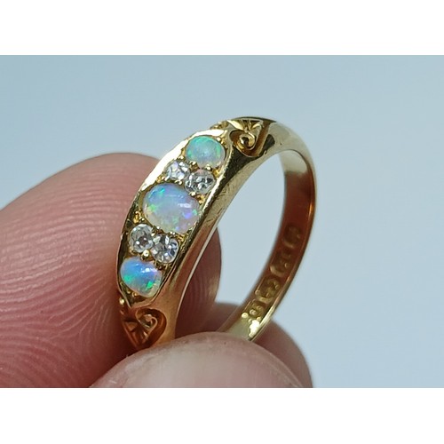 7 - A Victorian opal and diamond ring, the old European cut diamonds weighing approximately 0.10ct, the ... 
