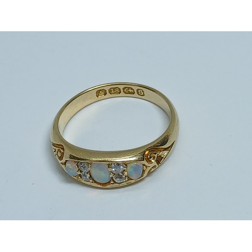 7 - A Victorian opal and diamond ring, the old European cut diamonds weighing approximately 0.10ct, the ... 