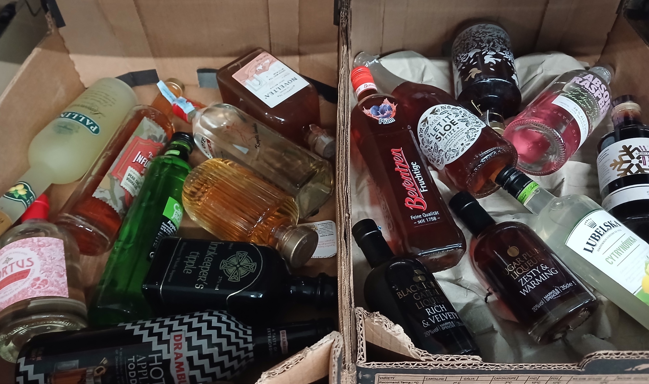 Two boxes of assorted alcohol.