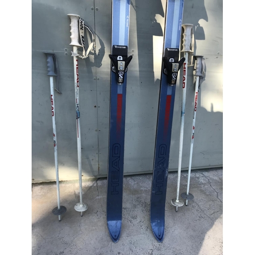 137 - Pair of Head Elite Skis with 4 Sticks