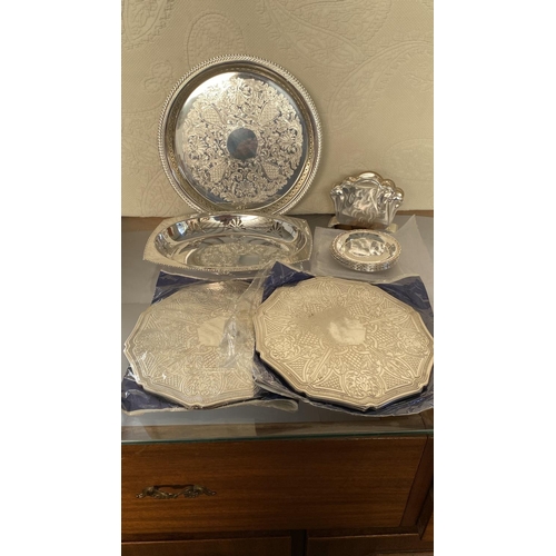 445 - Collection of Silver Plated Items, Round Tray, Bread Basket, x2 Table Mats, 6 Coasters and Napkin Ho... 