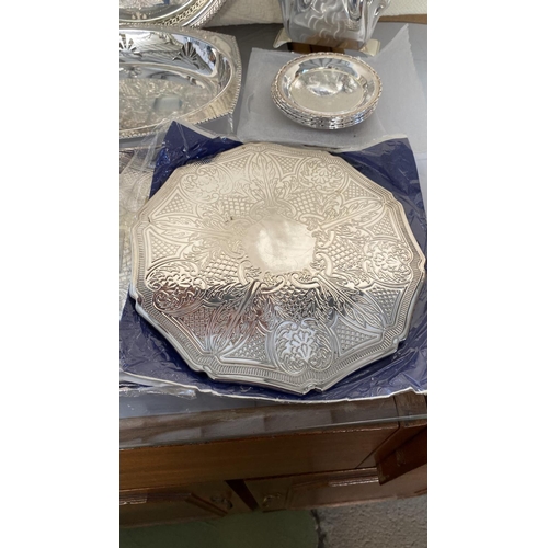 445 - Collection of Silver Plated Items, Round Tray, Bread Basket, x2 Table Mats, 6 Coasters and Napkin Ho... 