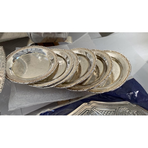 445 - Collection of Silver Plated Items, Round Tray, Bread Basket, x2 Table Mats, 6 Coasters and Napkin Ho... 