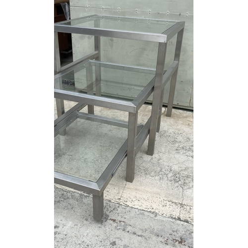 85 - Commercial Heavy Duty Nesting Tables in Brushed Aluminium and Glass (75 W. x 70 D. x 80cm H. Largest... 