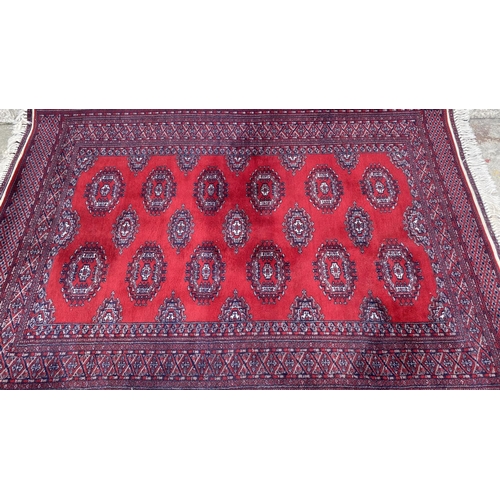 50 - Vintage Bukhara Hand Knitted Rug in Vibrant Red and Traditional Pattern (Tekke Gul Motif)