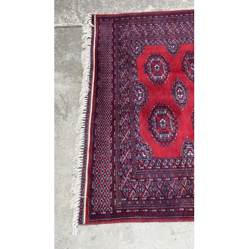 50 - Vintage Bukhara Hand Knitted Rug in Vibrant Red and Traditional Pattern (Tekke Gul Motif)