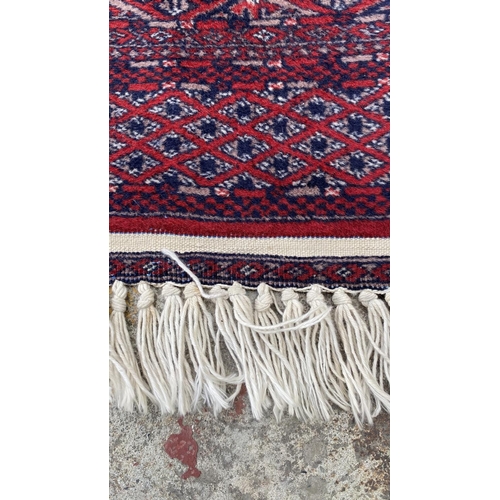 50 - Vintage Bukhara Hand Knitted Rug in Vibrant Red and Traditional Pattern (Tekke Gul Motif)