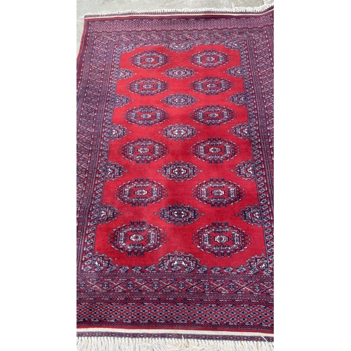 50 - Vintage Bukhara Hand Knitted Rug in Vibrant Red and Traditional Pattern (Tekke Gul Motif)