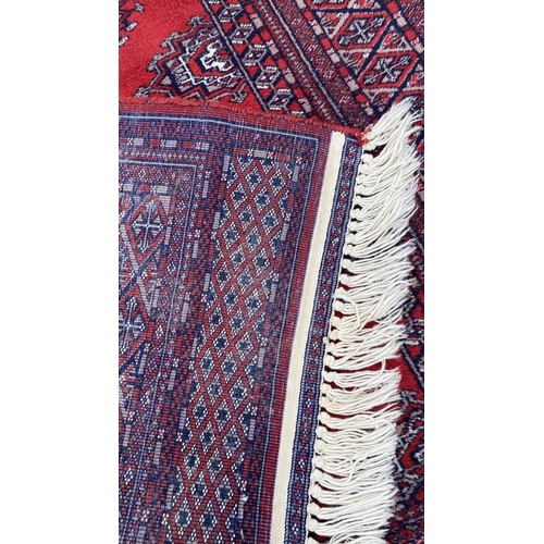 50 - Vintage Bukhara Hand Knitted Rug in Vibrant Red and Traditional Pattern (Tekke Gul Motif)