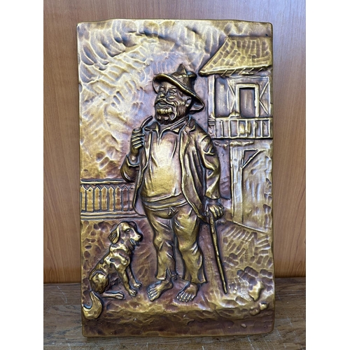 135 - Carved Copper Wall Ornament Man and Dog Depiction (29 x 47cm)