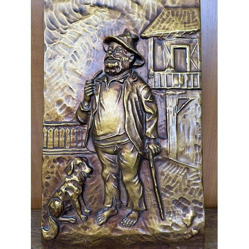 135 - Carved Copper Wall Ornament Man and Dog Depiction (29 x 47cm)