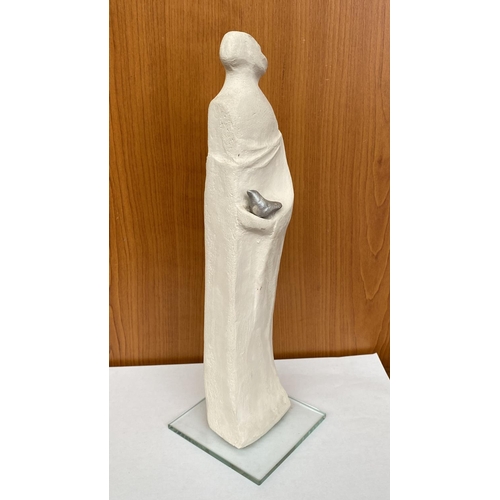 16 - Ceramic Woman's Figure Holding Bird on Glass Base Signed 'DR' in Greek (30cm H.)