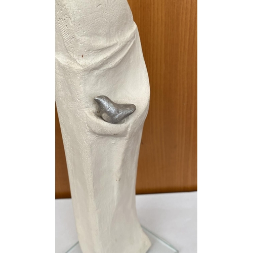 16 - Ceramic Woman's Figure Holding Bird on Glass Base Signed 'DR' in Greek (30cm H.)