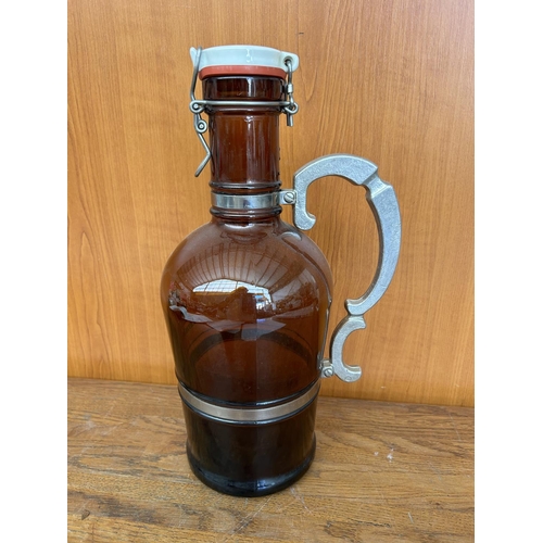 114 - Vintage Amber Glass Wine Bottle With Metal Handle and Porcelain Lid