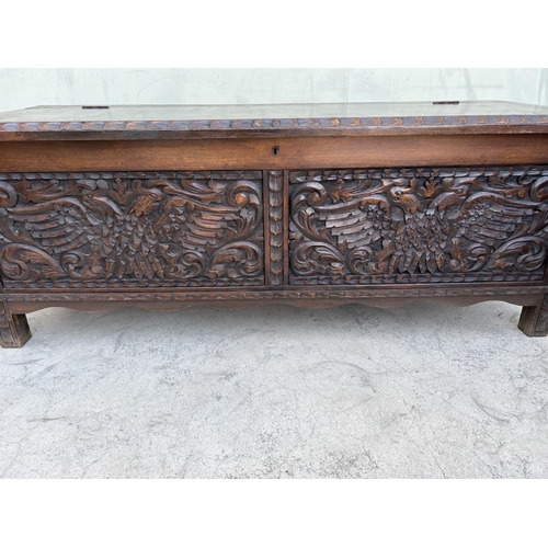 175 - Antique Solid Oak Trunk with Two Head Eagle Carvings (125 W. x 46 D. x 47cm H.)