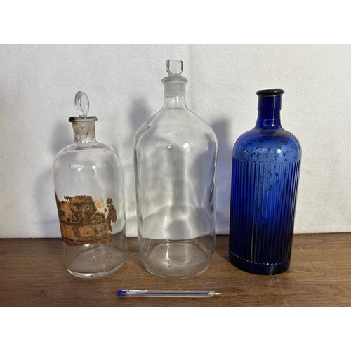 92 - Two Clear and One Blue Apothecary Bottles (x1 A/F)