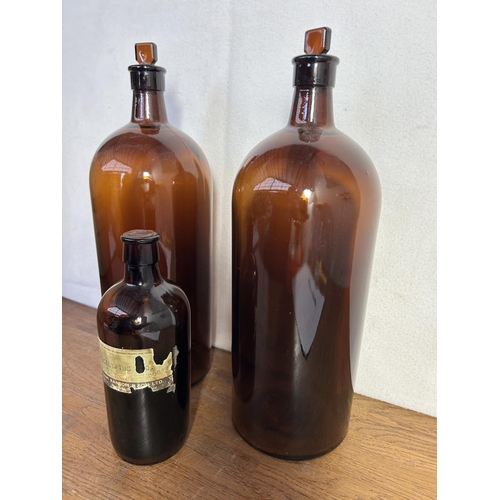 366 - Two Large Amber Apothecary Bottles with Stoppers and Another Small One