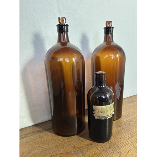 366 - Two Large Amber Apothecary Bottles with Stoppers and Another Small One