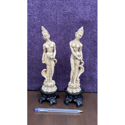 111 - x2 Asian Decorative Ivorine Resin Figurines on Black Resin 4-Footed Stand