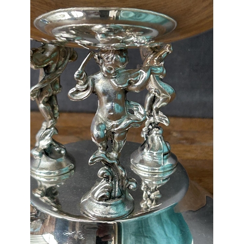 191 - Italian Silver Plated Center Piece Bowl Sitting on 3-Cherub Figures (30cm H., 20cm Diameter)
