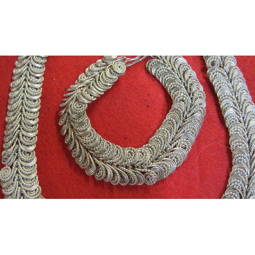 132 - A heavy pair of braided necklace and bracelet, possible low grade silver