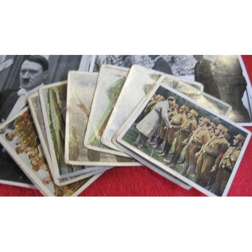 155 - A group of 35 Nazi collector's cards dating to the 1930s featuring Adolph Hitler, plus a selection o... 