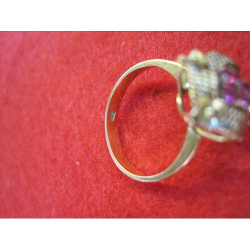 140 - A yellow metal ring which appears to be marked 14ct set with 6 red stones, possibly amethysts, total... 