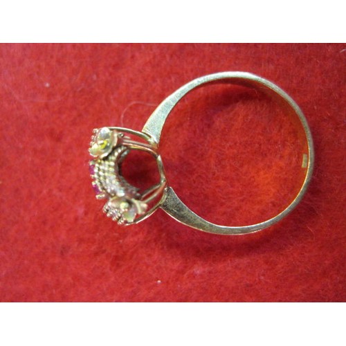 140 - A yellow metal ring which appears to be marked 14ct set with 6 red stones, possibly amethysts, total... 