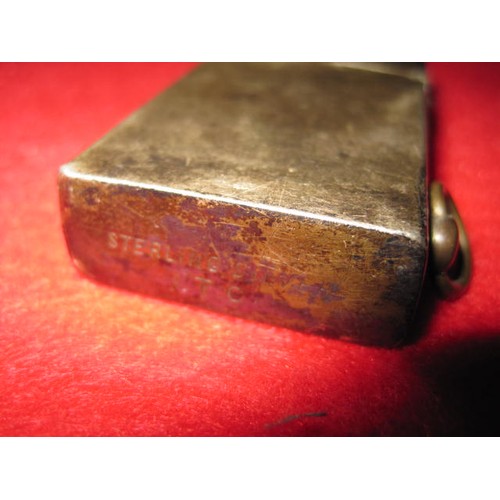 281 - A sterling silver petrol cigarette lighter marked 'Sterling Silver' and 'I.T.C.', the action spring ... 