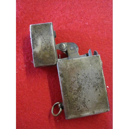 281 - A sterling silver petrol cigarette lighter marked 'Sterling Silver' and 'I.T.C.', the action spring ... 