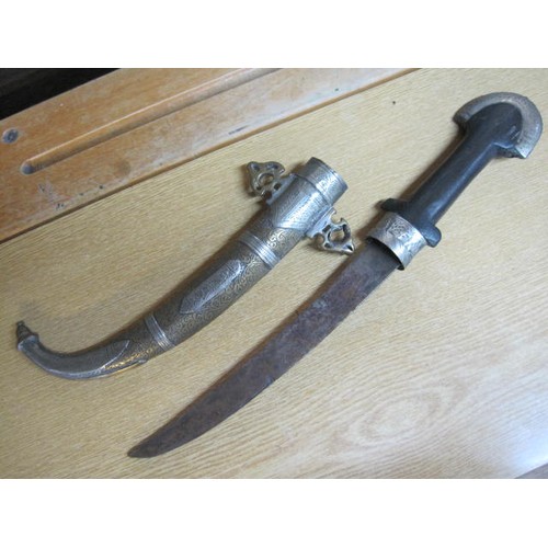 189 - An antique Arabic dagger in ornate scabbard