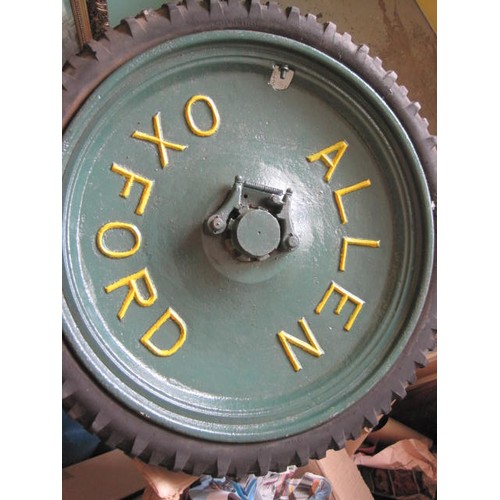 322 - A coffee table made from a pair of cast agricultural wheels and axle, in good order