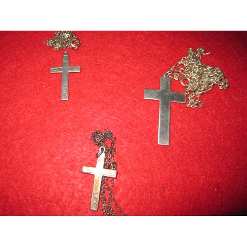 288 - One medium and two small .925 silver crucifixes, all mounted on silver chains, total approximate wei... 