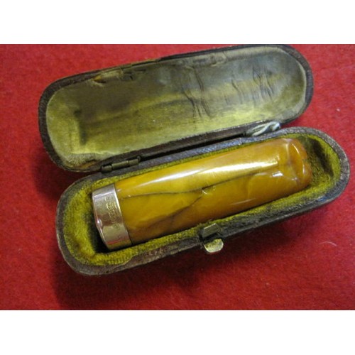 234 - A vintage cased cigar or cheroot holder in possibly amber of butterscotch colour with a 15ct gold ri... 