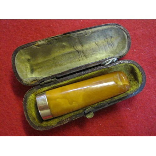 234 - A vintage cased cigar or cheroot holder in possibly amber of butterscotch colour with a 15ct gold ri... 