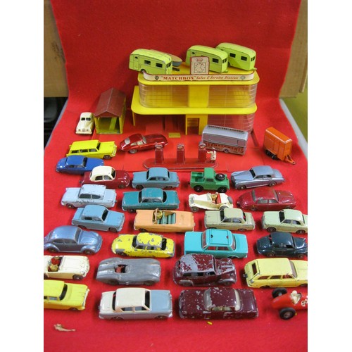 310 - A vintage Matchbox garage and an assortment of vintage Matchbox and Lesney toy cars (approx 30) in m... 