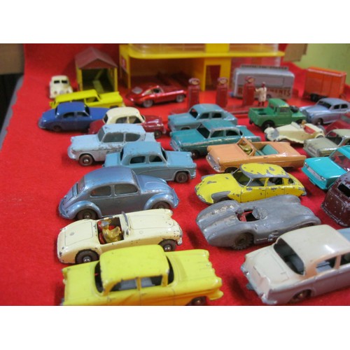 310 - A vintage Matchbox garage and an assortment of vintage Matchbox and Lesney toy cars (approx 30) in m... 