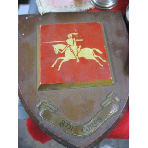 153 - A box containing an assortment of military and related items, including a vintage 8th Corps plaque b... 