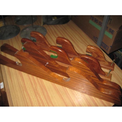 182 - A pair of wooden wall mounted gun racks, one for 2 guns and one for 3.