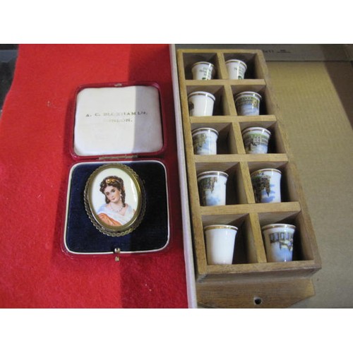 A Limoges porcelain brooch and a small display box of thimbles