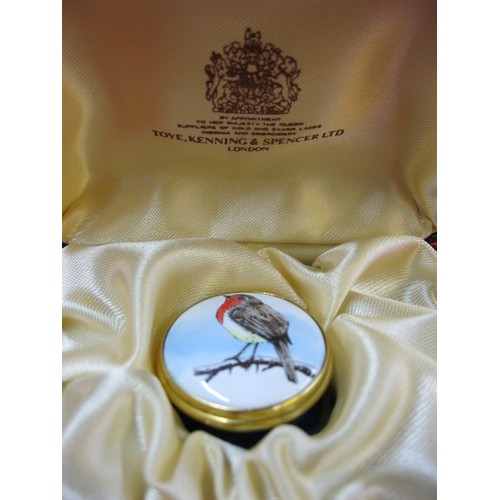 A cased enamel pillbox by Toye, Kenning & Spencer Ltd featuring a robin ...
