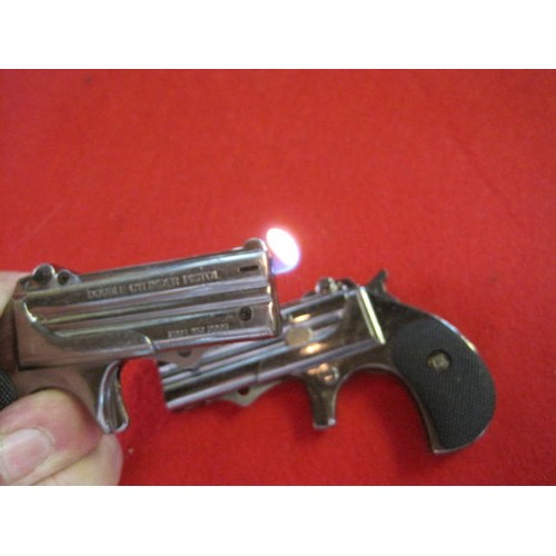 155 - A pair of cigarette lighters styled as derringer-type pistols, both in working order