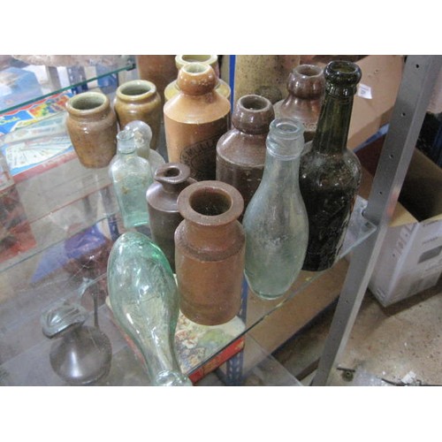 32 - Assortment of antique bottles and stoneware containers, many named