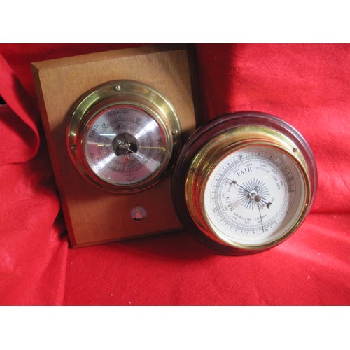 4 - A pair of barometers mounted on wooden plinths